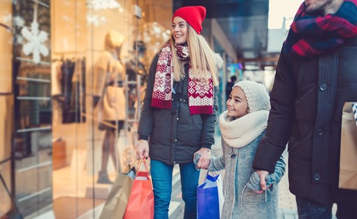 A family of three shopping in the winter